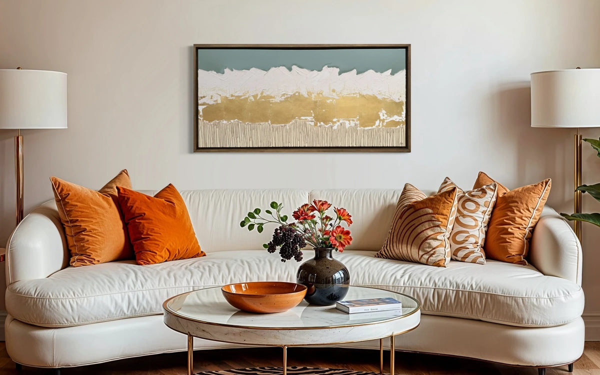 Wide framed abstract above a cream sofa